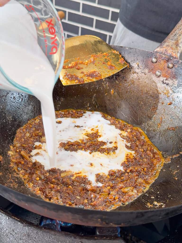 Adding curry powders to wok