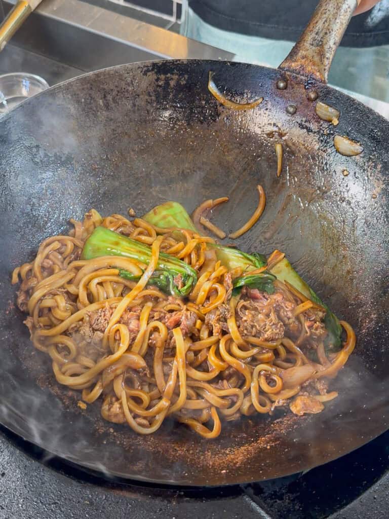 Bok choy wilting into beef udon stir fry