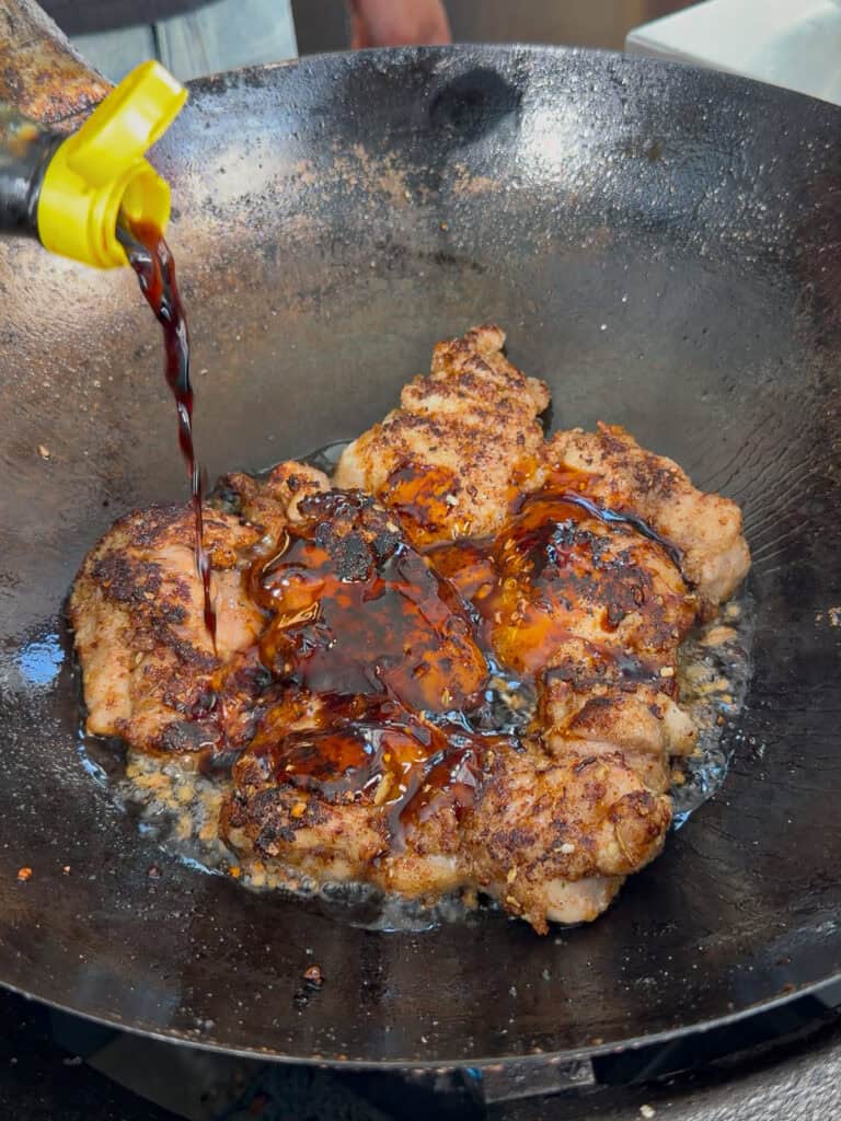 Chicken turning glossy as sauce caramelises