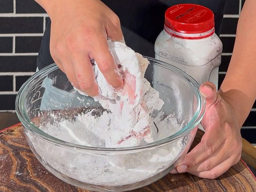 Cornstarch added over raw chicken pieces