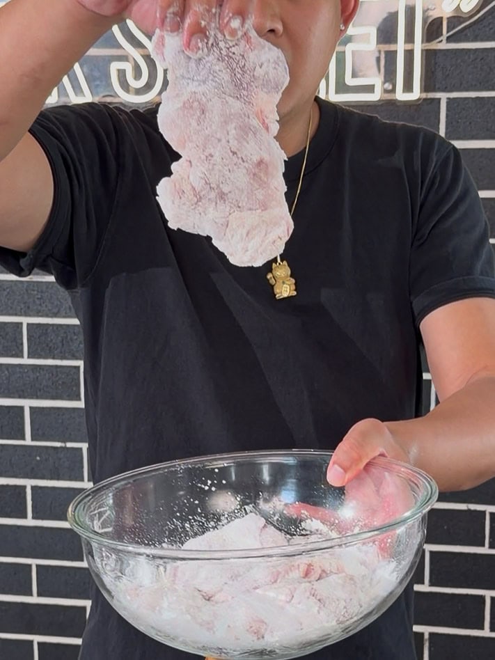 Cornstarch-coated chicken resting while wok heats