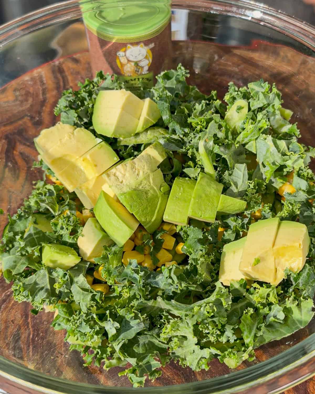 Kale corn and avocado arranged in bowl
