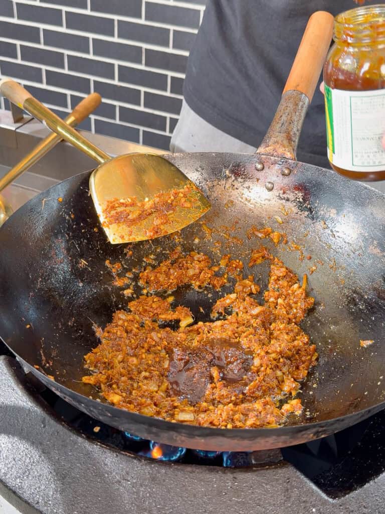 Prepared onion and garlic mixture in wok