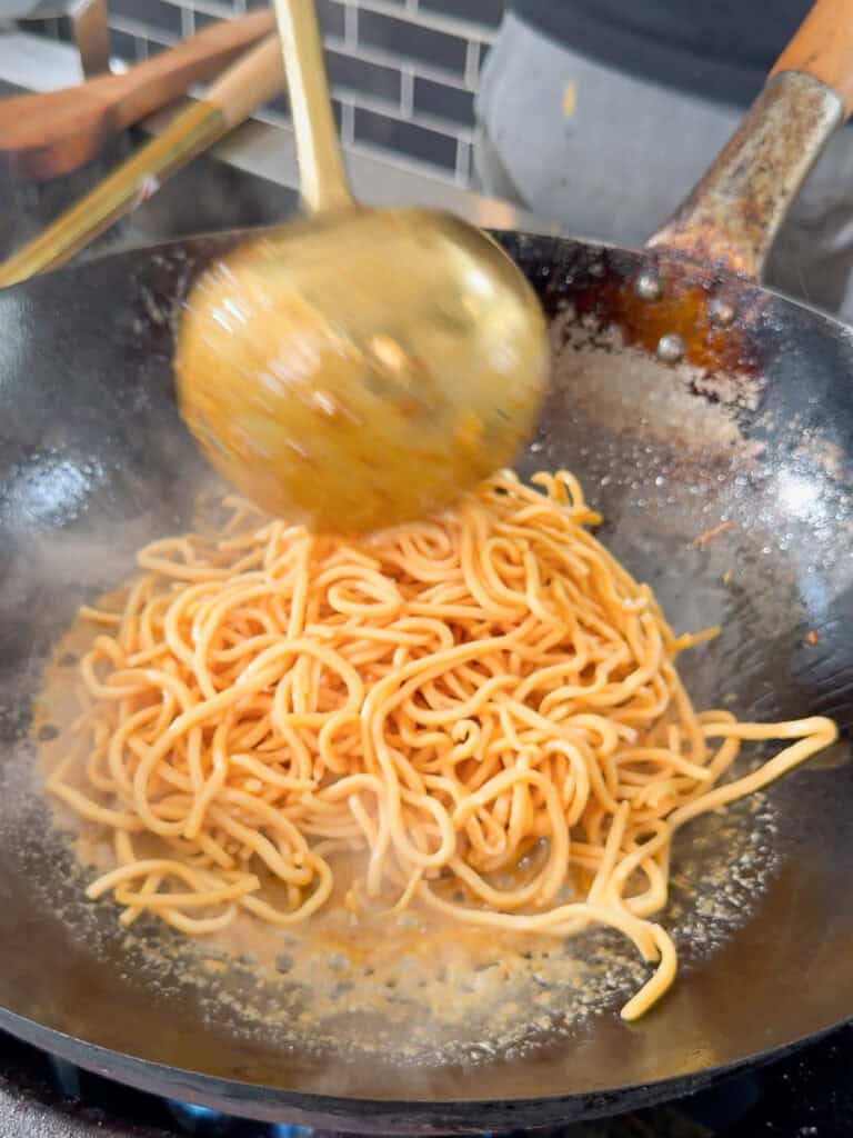 Same mixture spread evenly across wok