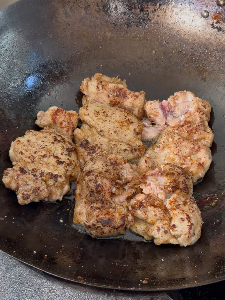 Chicken beginning to turn lightly golden while searing