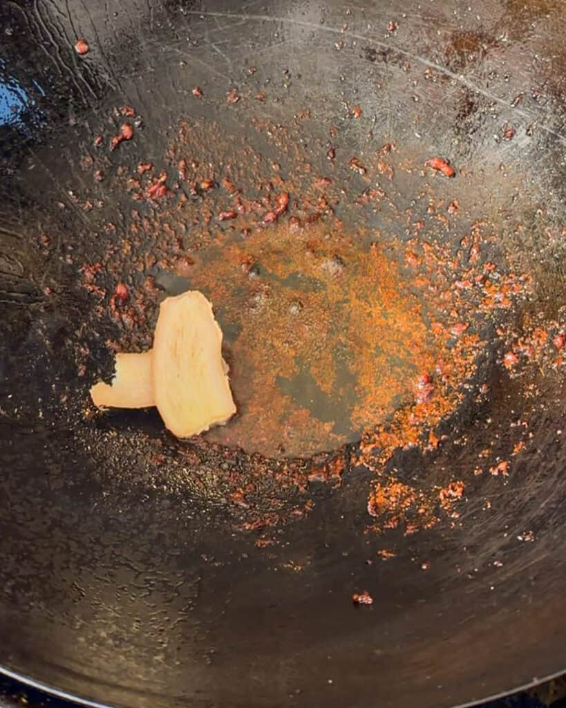 Ginger slice added to wok