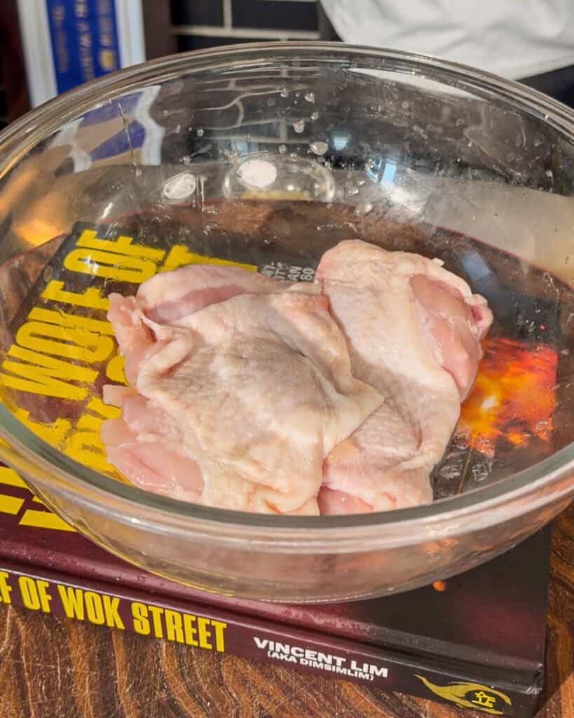 Raw chicken placed in glass bowl