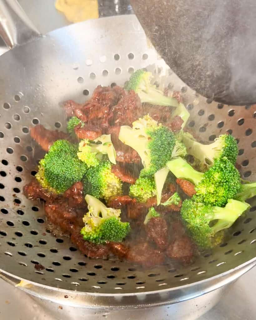 Beef and Broccoli Fried Rice beef and broccoli resting in a metal strainer after cooking