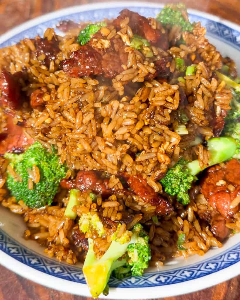 Beef and Broccoli Fried Rice close up of dark mixed rice with beef and broccoli in a bowl