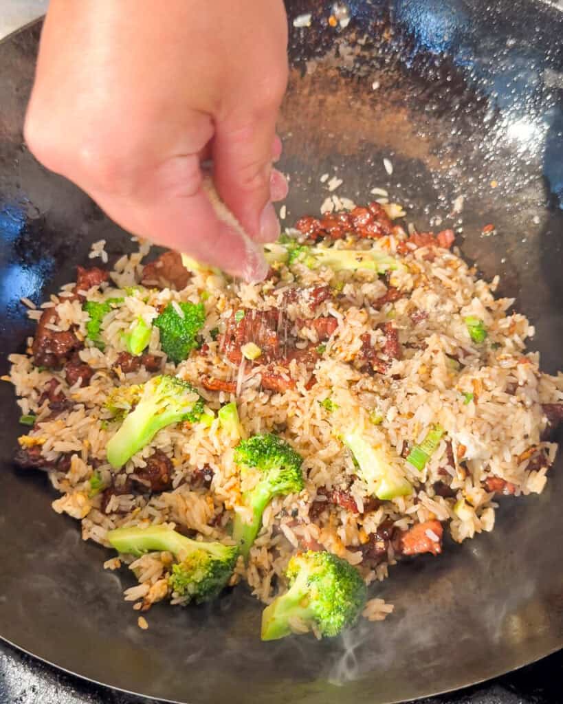 Beef and Broccoli Fried Rice rice mixed with beef and broccoli in a black wok